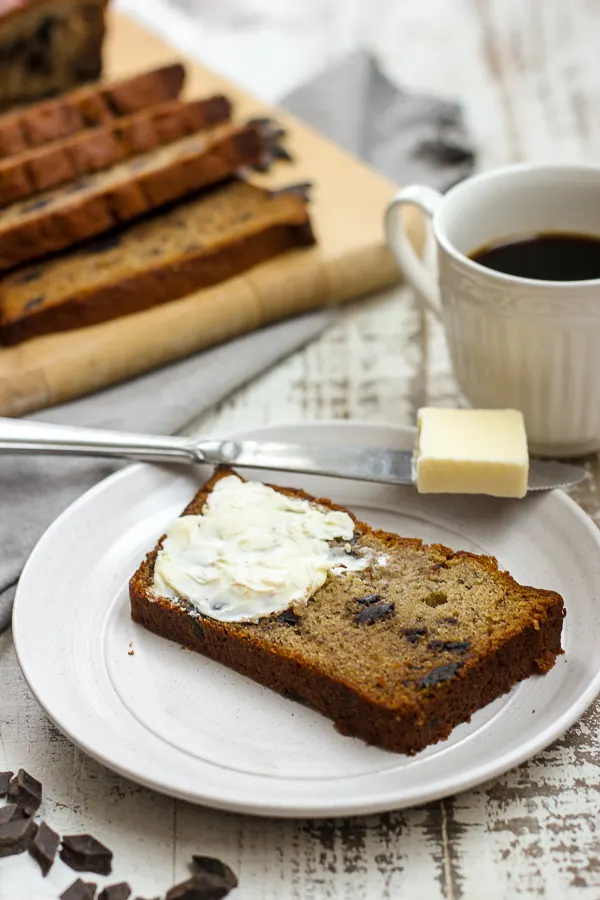 close up showing banana bread with butter spread on the slice