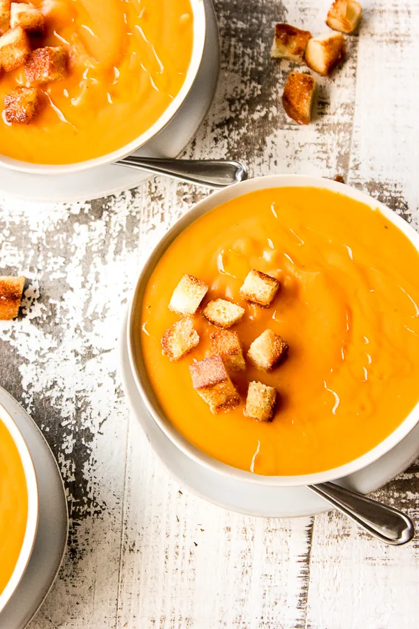 Sweet potato bisque in a bowl topped with homemade croutons