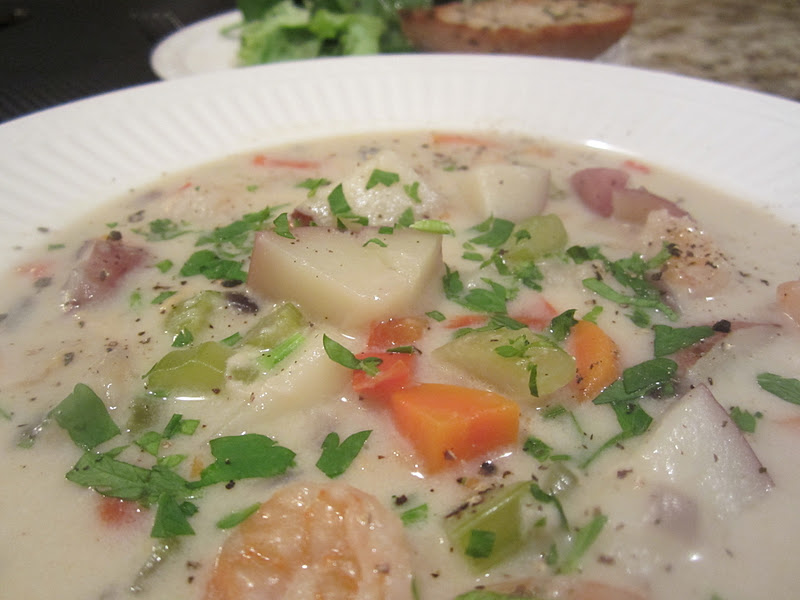 close up of seafood chowder being served in a bowl