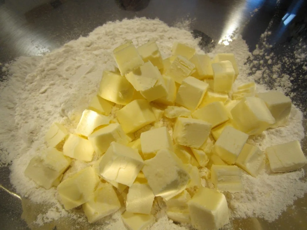 Flour and cubed butter together in a mixing bowl
