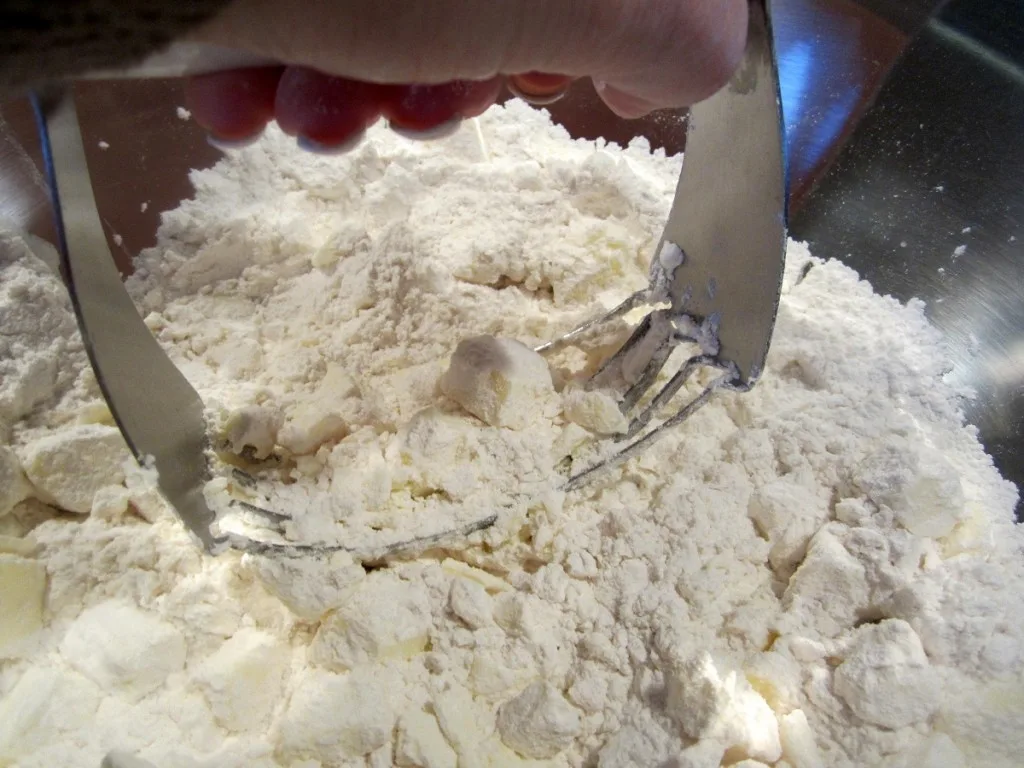 mixing butter and flour together with a pastry blender