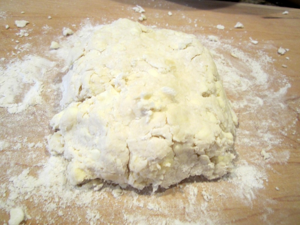 Dough turned out onto a board ready to start rolling out
