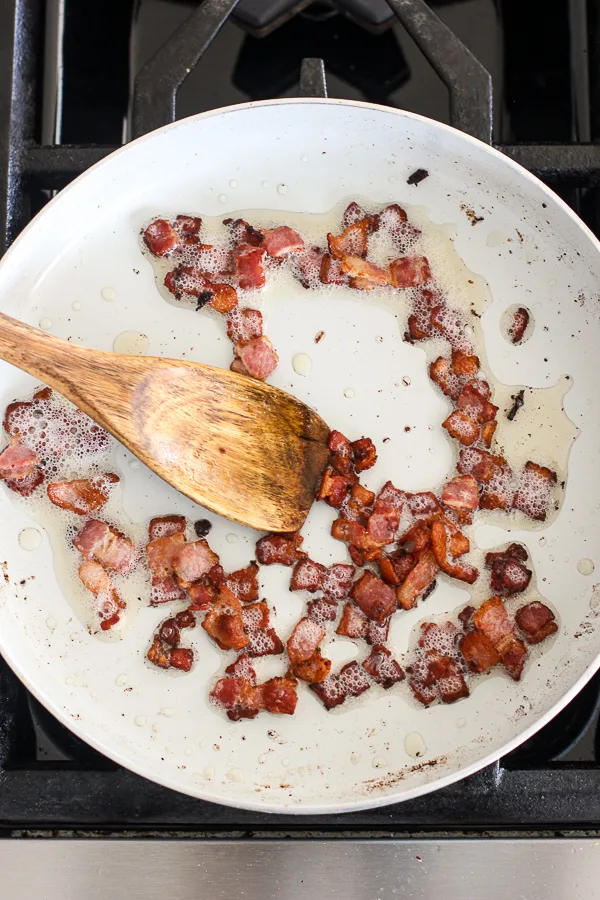 Showing the bacon bits in the skillet after frying.