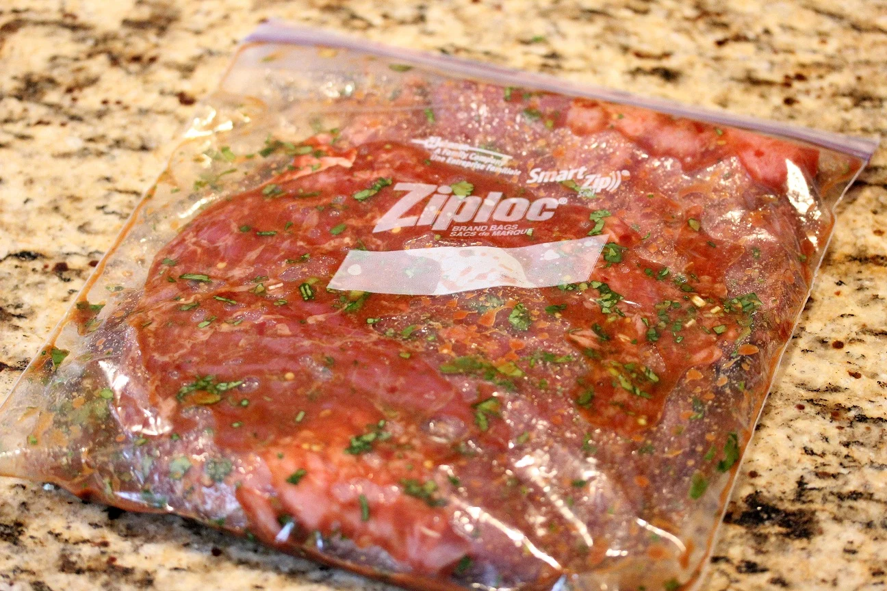 Steak in a plastic storage bag with the marinade