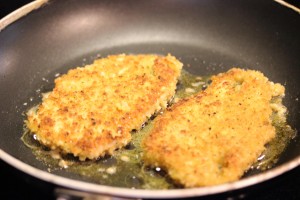 easy and delicious chicken caprese breaded and frying in a skillet
