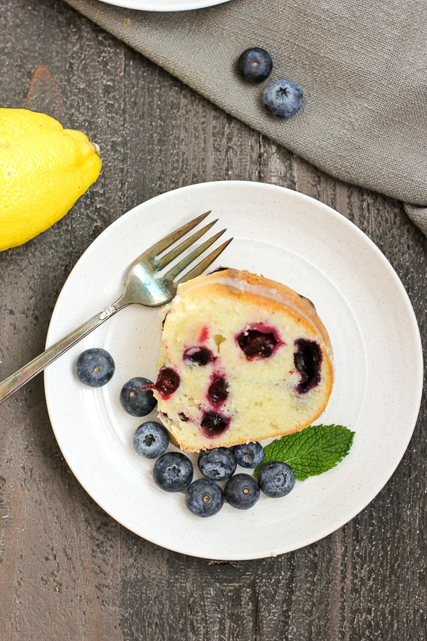 Overhead shot showing finished cake plated and garnished with fresh blueberries