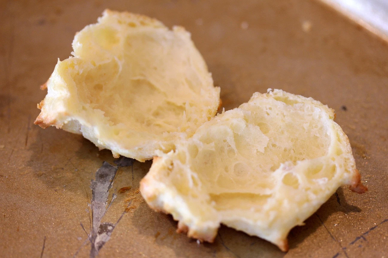 Splitting the cream puffs in half before filling with the cream