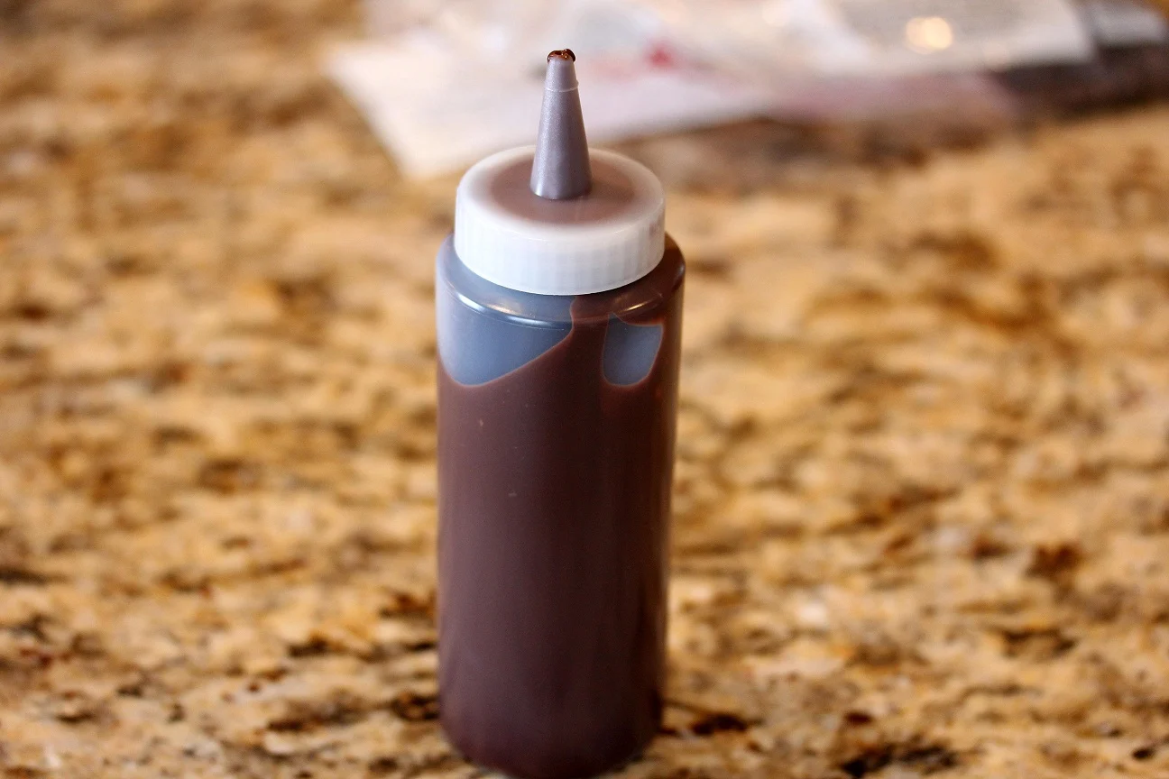 The chocolate drizzle in a bottle with a tip