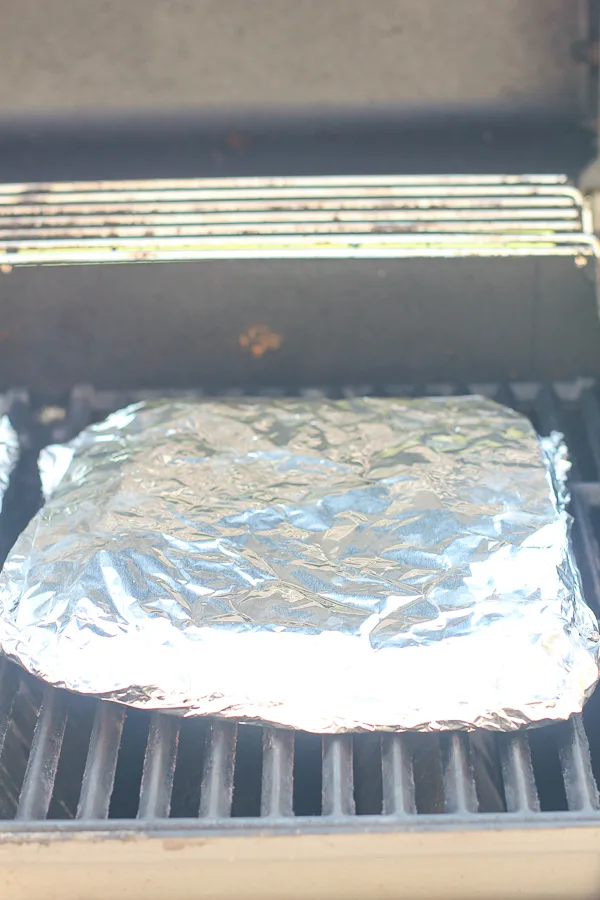 The foil packet of potatoes on the grill