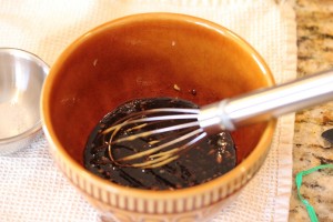 Balsamic vinaigrette in a mixing bowl with a whisk