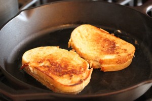 Sandwiches being grilled in a cast iron pan