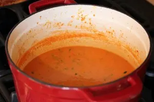 soup in the pot after stirring in the chopped basil