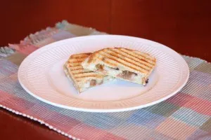 pear and onion panini cut in two on a plate