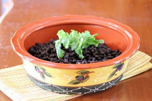 bowl of slow cooker black beans with garnish on top