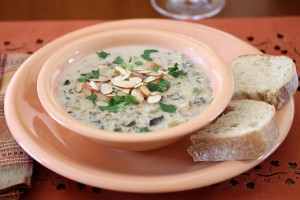 bowl of chicken wild rice soup with two pieces of bread on the side
