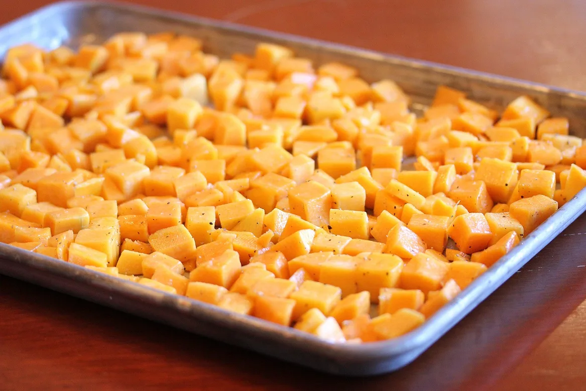 Diced squash on the baking sheet before roasting