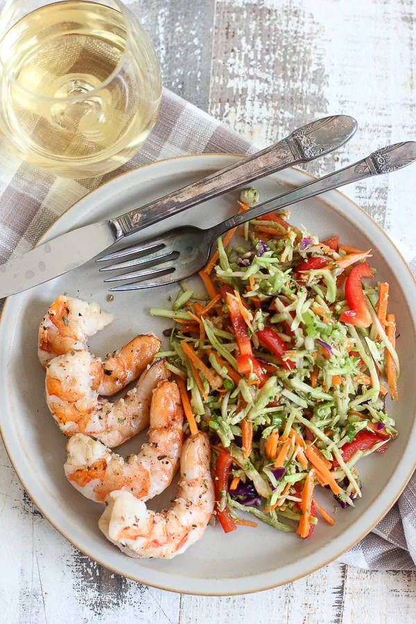 Asian broccoli slaw served with grilled shrimp and a glass of white wine