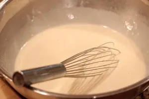 beer batter in a mixing bowl after whisking it together