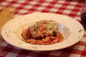 Plated chicken parmesan served over noodles tossed in marinara sauce for the fabulous homemade Italian dinner