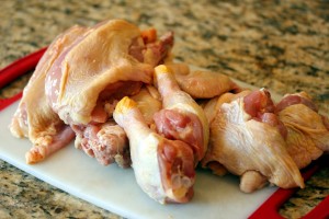 chicken legs and thighs on a cutting board