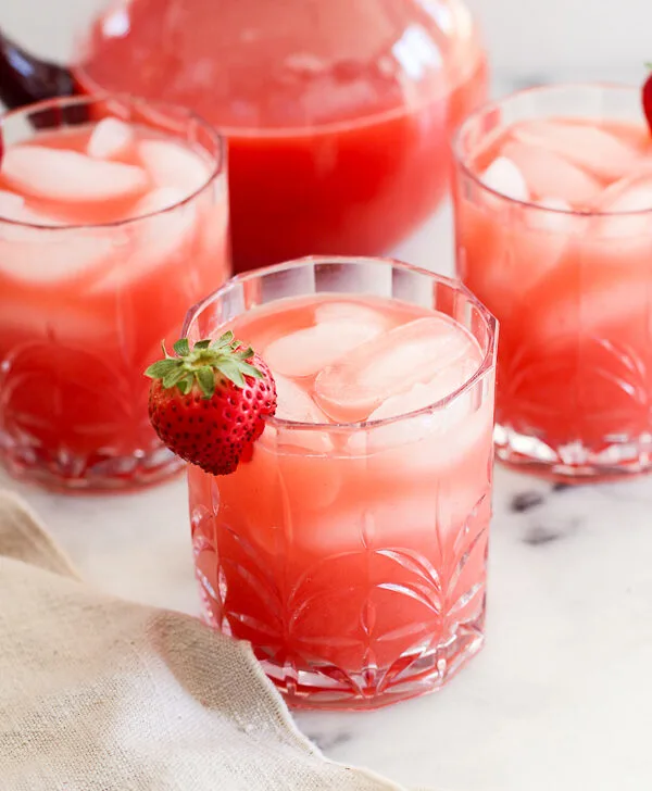 Fresh Strawberry Margaritas in cocktail glassed garnished with a strawberry