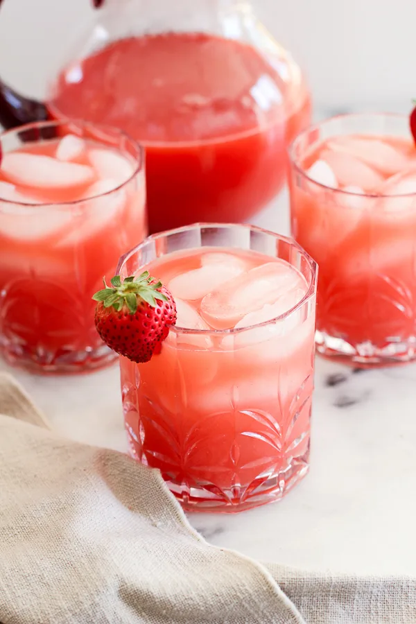 Fresh Strawberry Margaritas in cocktail glassed garnished with a strawberry