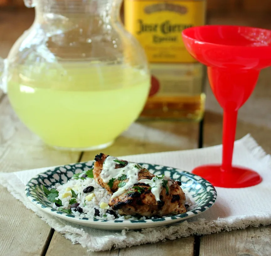 Margarita Chicken with fiesta rice plated and served with a margarita cocktail.