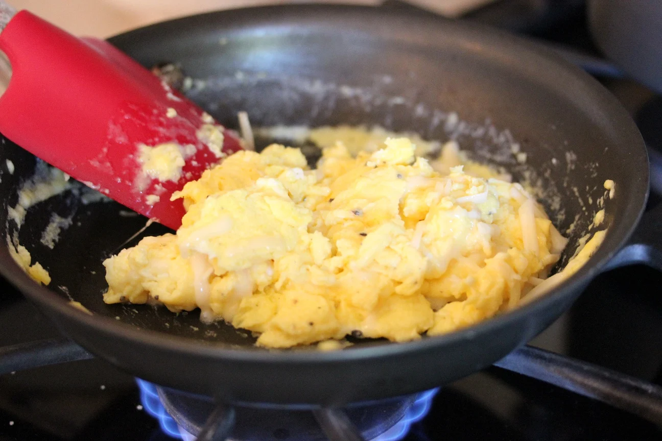 Process shots of eggs cooking in a skillet