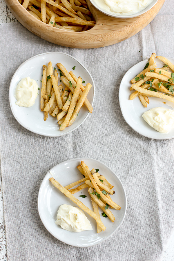 French fries being served with truffle aioli for dipping.