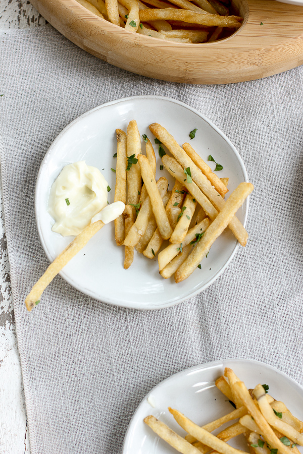 French fries being served with truffle aioli for dipping