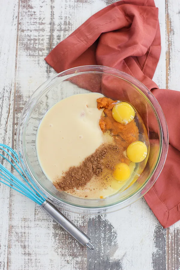 The pumpkin mixture ingredients in the mixing bowl before whisking together