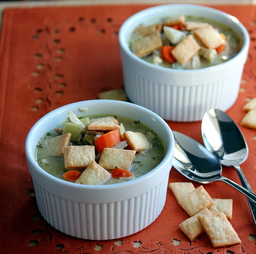 Chicken Pot Pie soup served in a ramekin and topped with baked pie crust squares