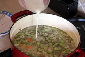 Pouring the milk and flour slurry into the soup