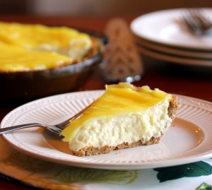 a slice of lemon cream pie on a plate with a fork