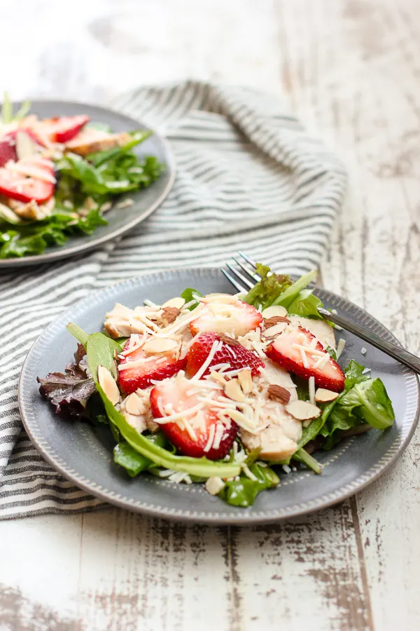 Two plated grilled chicken strawberry salad