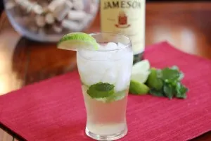 Cocktail in the glass garnished with lime and mint