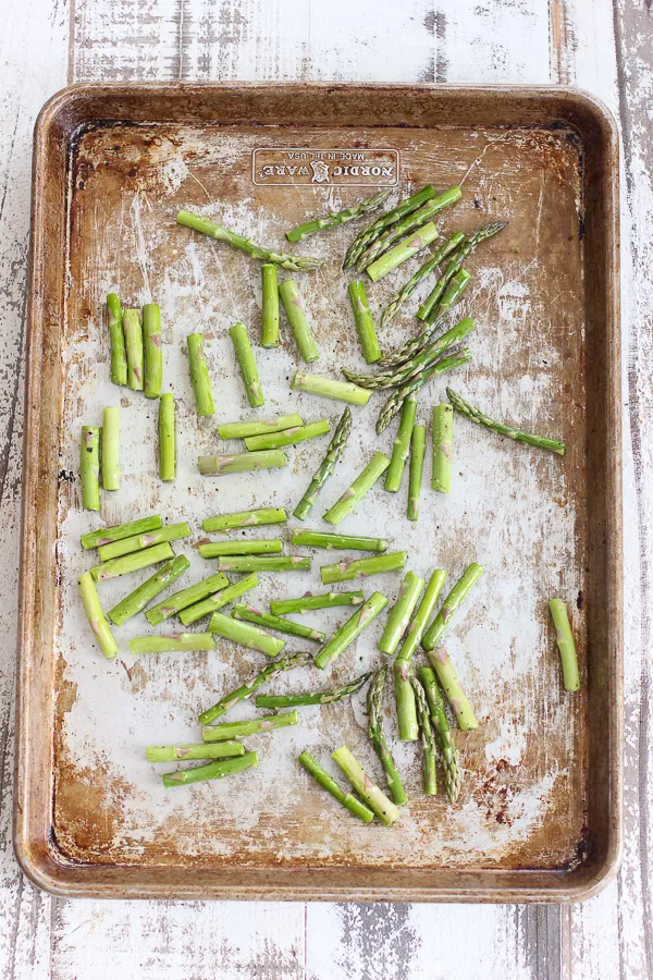 Asparagus ready for roasting on the sheet pan