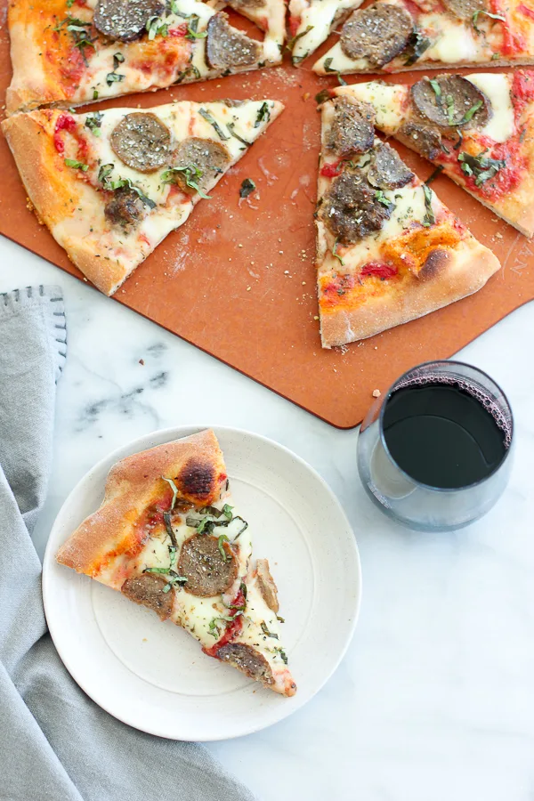 Pizza served with red wine.