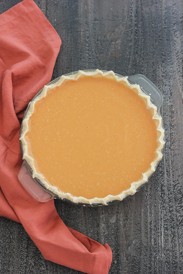 Overhead photo of maple pumpkin pie before it goes into the oven to bake