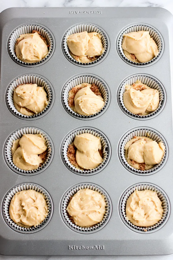 Unbaked Cinnamon Roll Muffins ready for the oven in a muffin tin