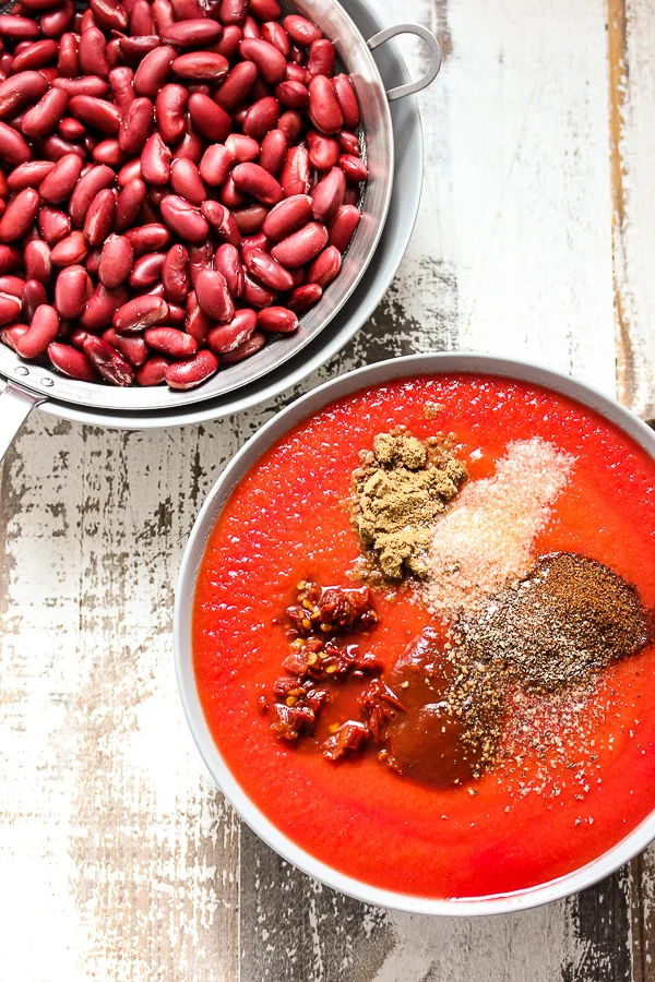 Showing the beans, tomato sauce and spices that go into the enchilada casserole