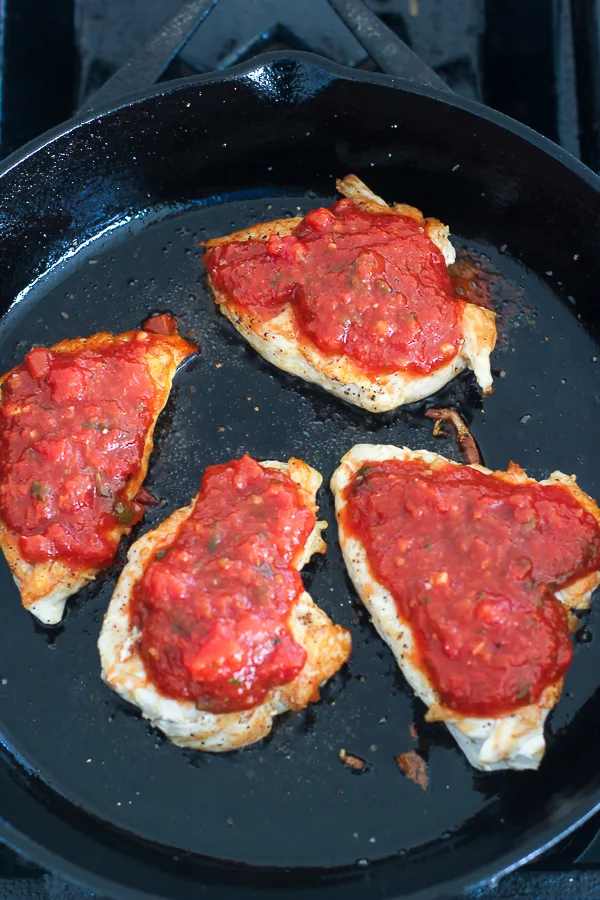 The seared chicken breasts topped with marinara