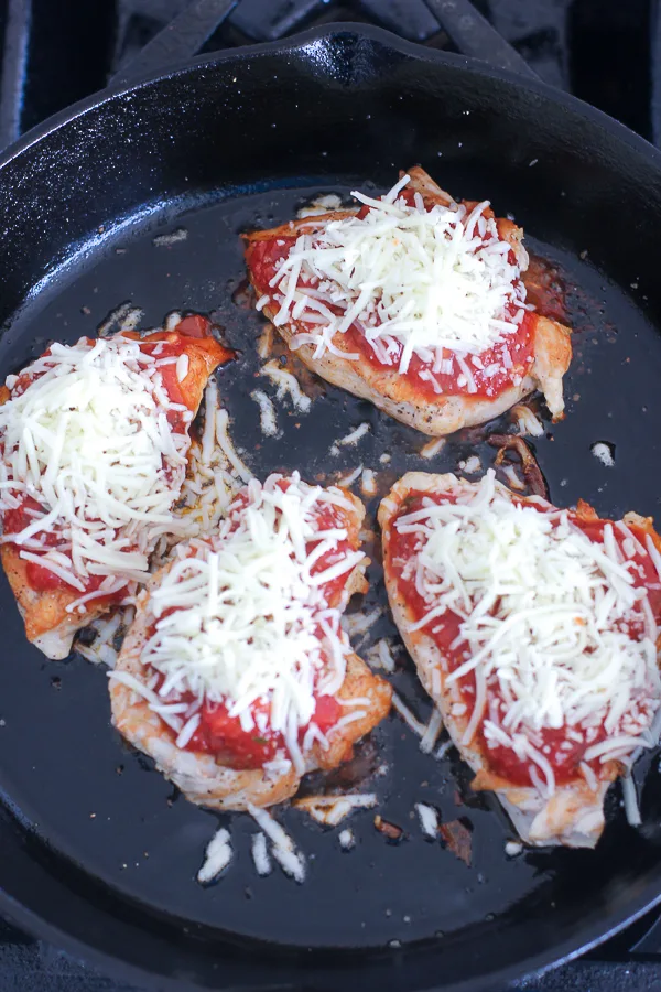 The seared chicken breasts topped with marinara, shredded mozzarella and grated parmesan 