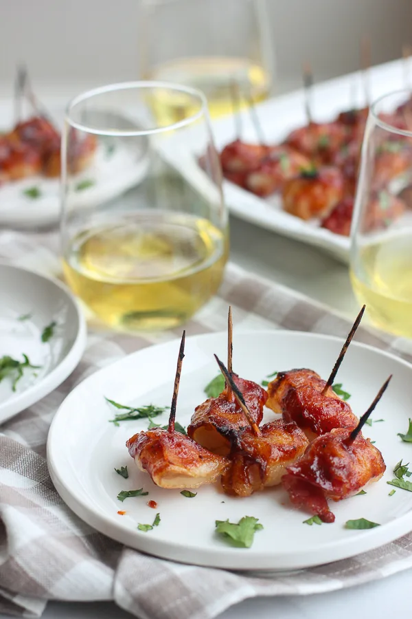 BBQ bacon water chestnuts plated and served with wine
