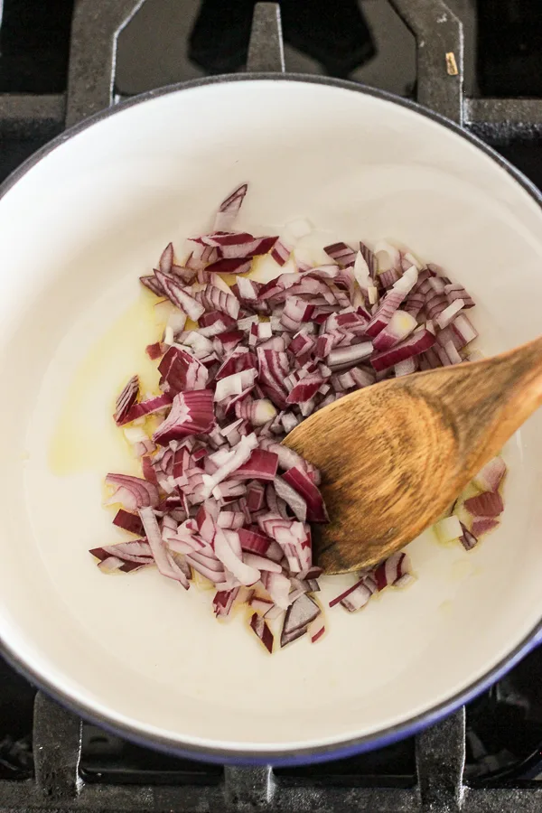 Sautéing onions in olive oil in a pan