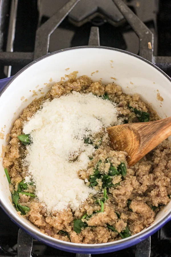 Adding grated parmesan to the pan before stirring in