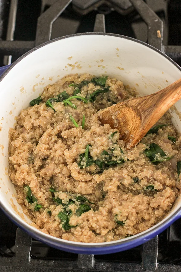 Completed spinach parmesan quinoa after stirring in the parmesan in the pan