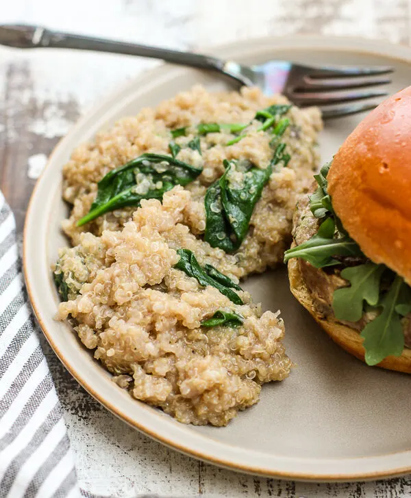 Spinach Parmesan Quinoa plated with a burger