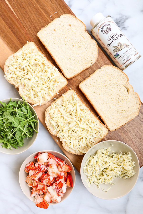 Showing the shredded cheese on the bread as the sandwich is being assembled