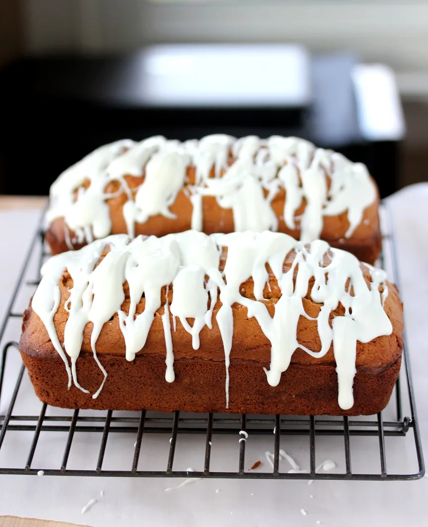 This pumpkin bread is incredibly moist and delicious, and a cream cheese glaze makes it over the top delicious! Plus it makes not one, but two loaves.